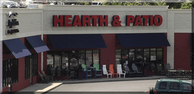 The Hearth & Patio storefront, with navy awnings and patio chairs set out front